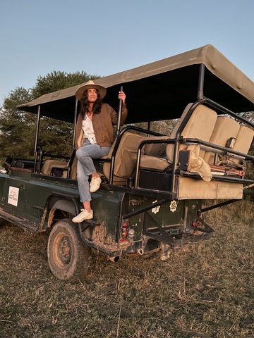 On the back of a safari truck at golden hour